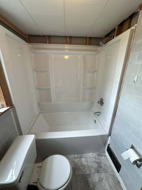 a bathtub and shower combo after installation